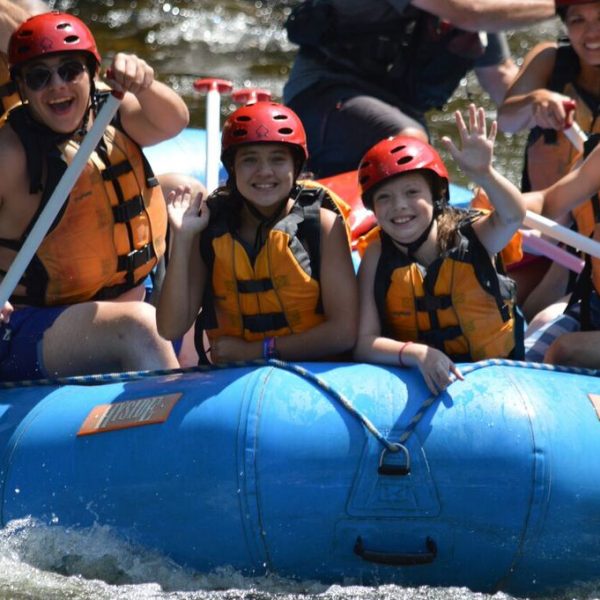 Family enjoying whitewater rafting in Maine.