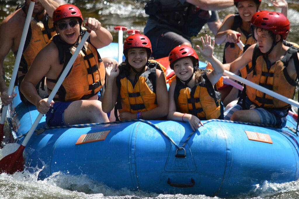 Family enjoying whitewater rafting in Maine.