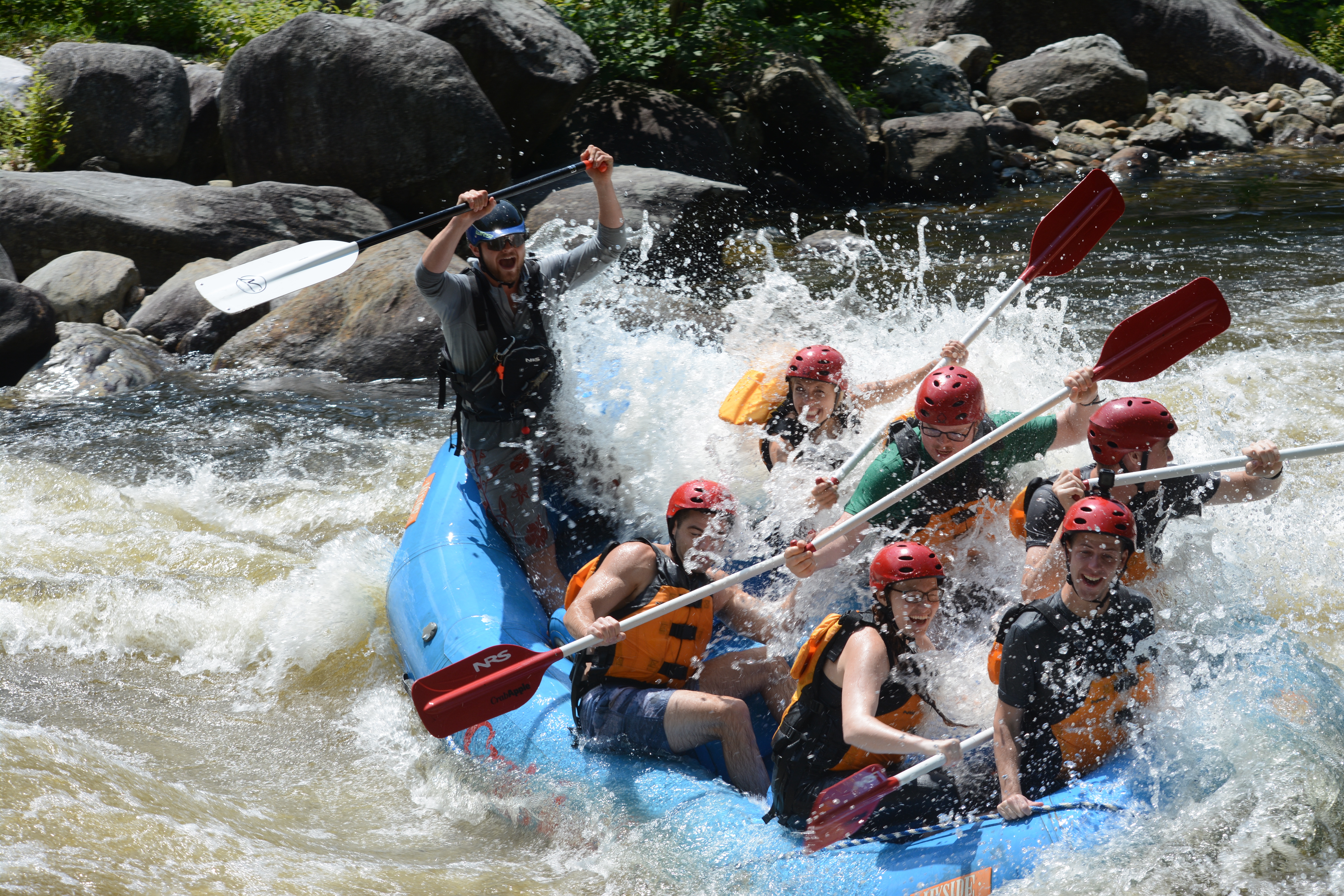 Group of rafters about to fall out of their raft.