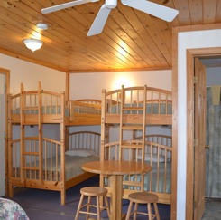 Spring Cottage bedroom with two sets of bunk beds and a small table