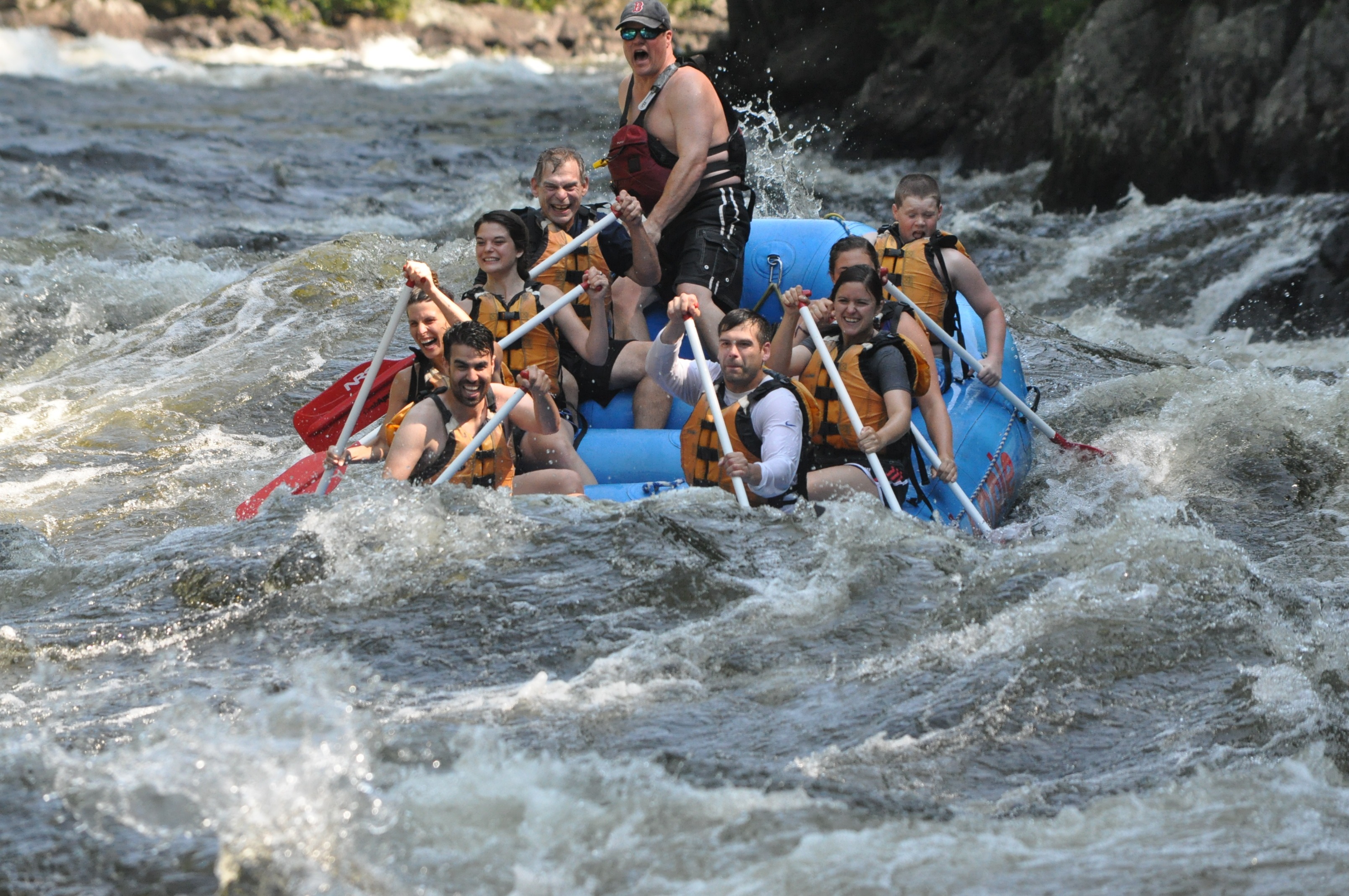 Group of eight rafts down the Kennebec River.