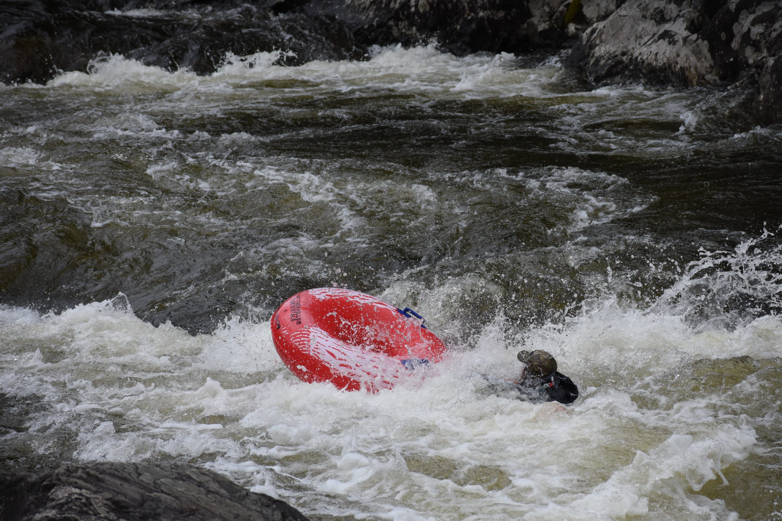 person in the river after falling off the tube